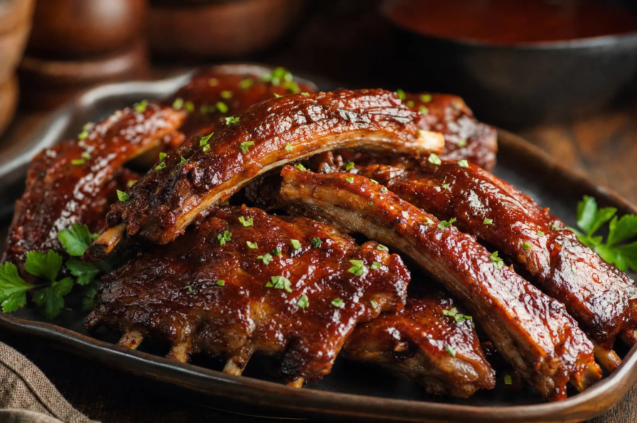 Keto pressure cooker pork ribs — fall-off-the-bone ribs with a glossy sugar-free barbecue glaze, garnished with parsley on a platter
